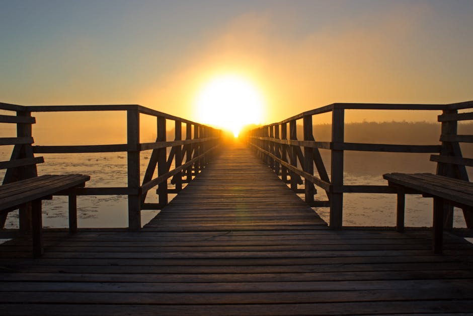 A breathtaking sunrise over a wooden pier, perfect for relaxation and reflection by the water.